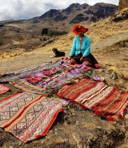 woman with rugs peru