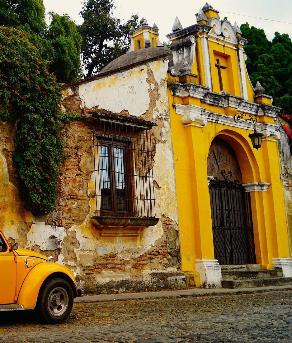 yellow car next to yellow building